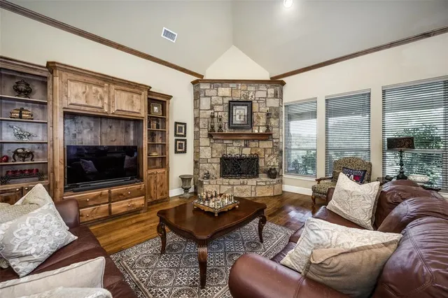 a living room with furniture a flat screen tv and a large window