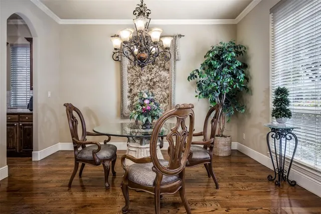 a view of a dining room with furniture and chandelier