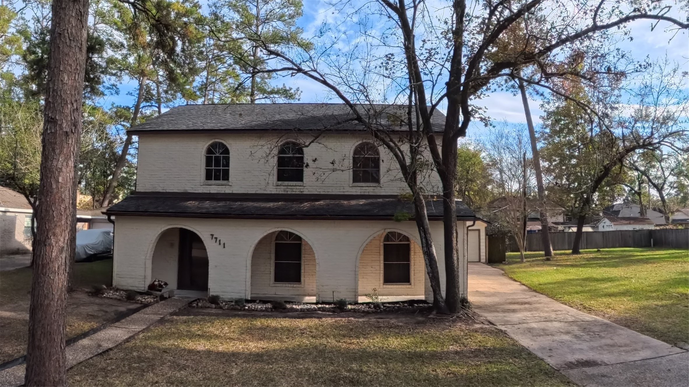 7711 Kleingreen Lane Spring, TX 77379 - Photo 1 of 14 a front view of a house with garden