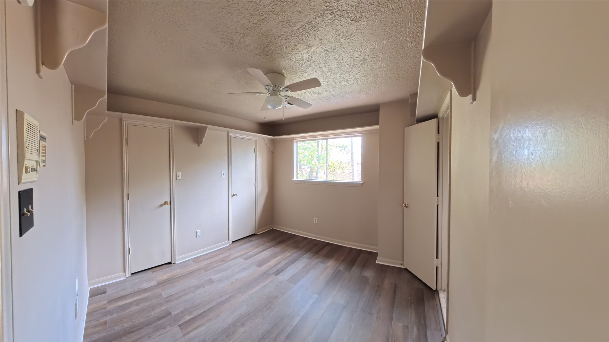 7711 Kleingreen Lane Spring, TX 77379 - Photo 11 of 14 a view of an empty room with wooden floor and a window