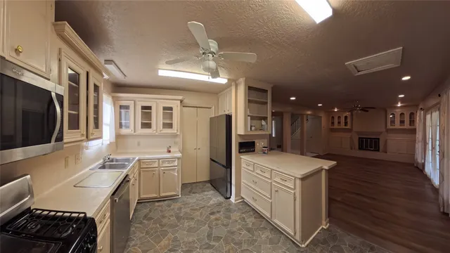 a kitchen that has a lot of cabinets in it