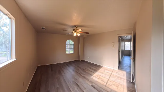 wooden floor in an empty room with a window
