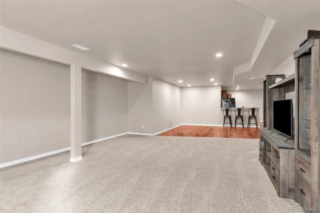 a view of a livingroom with furniture and a flat screen tv