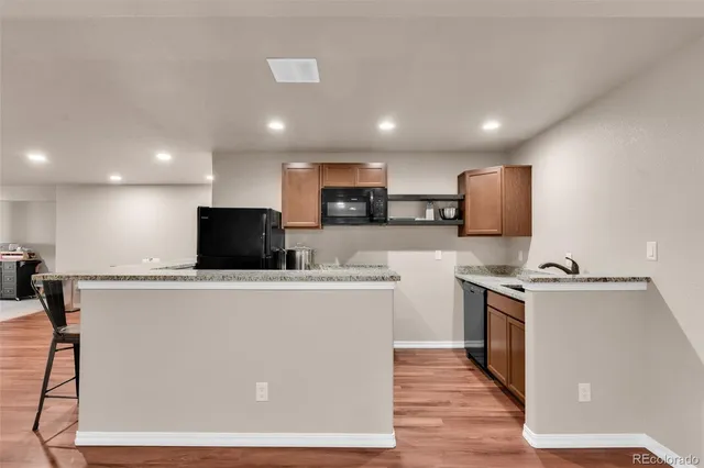 a view of kitchen with microwave a stove and a refrigerator