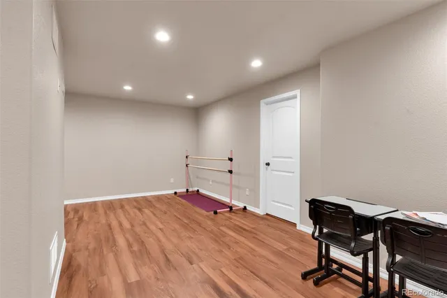 a view of a workspace with wooden floor