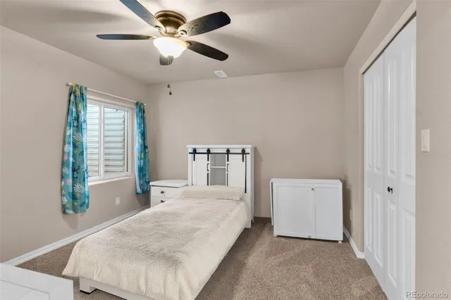 a spacious bedroom with a bed and a chandelier