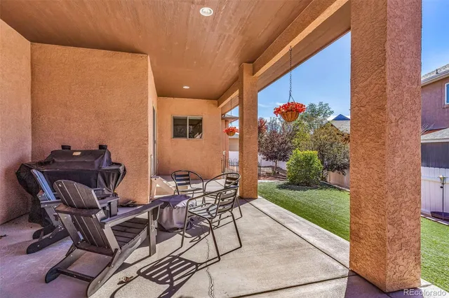 a front view of a house with garden and patio
