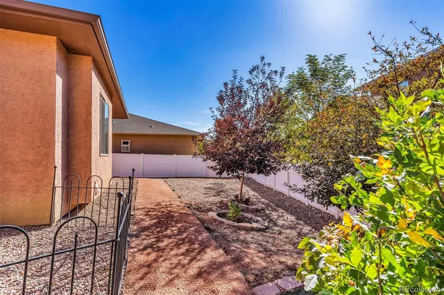 a view of a backyard with plants and a patio