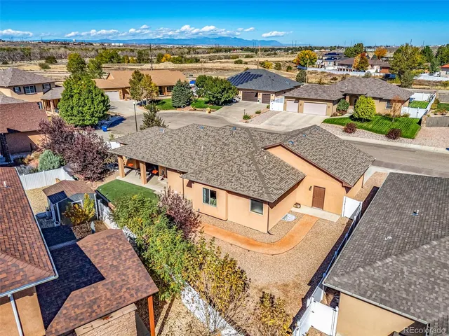 an aerial view of residential houses with outdoor space