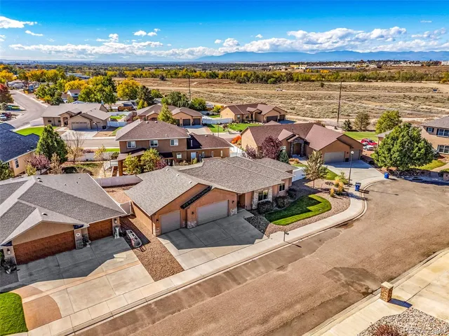 an aerial view of residential houses with outdoor space
