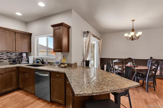 a kitchen with a kitchen island a sink cabinets and wooden floor