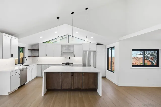 a kitchen with a sink stainless steel appliances a counter space and a window