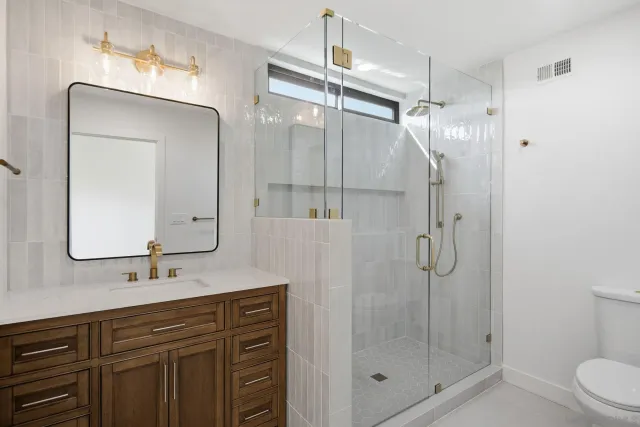 a view of a backyard with a barbeque and wooden fence