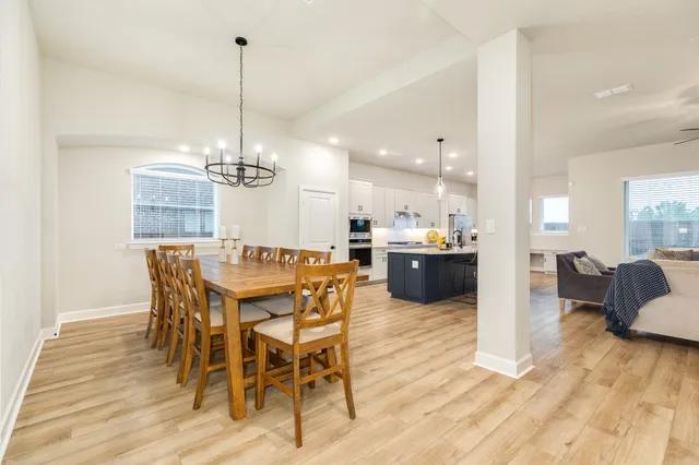 a living room with couches and a flat screen tv with wooden floor