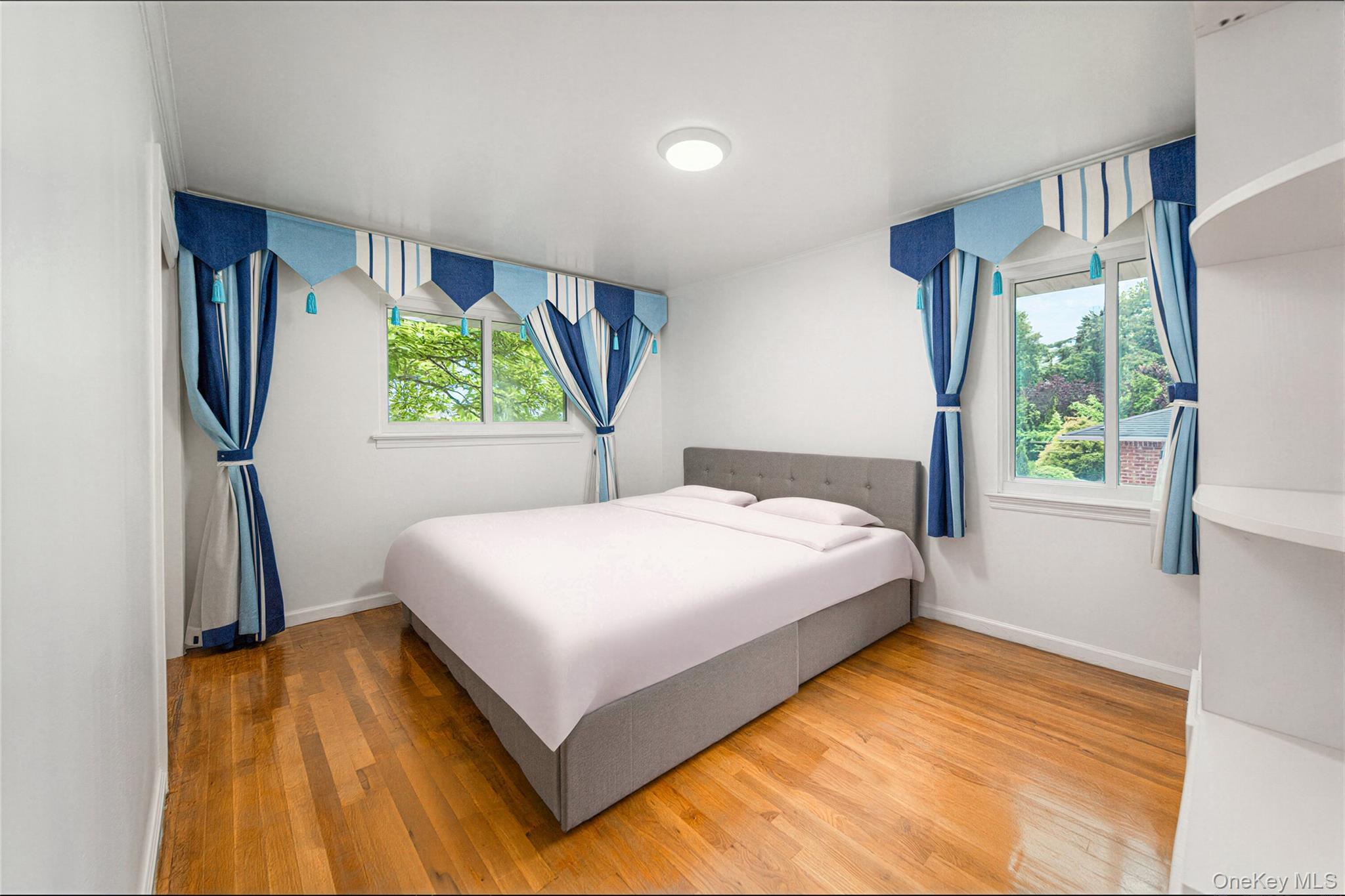 105 Seaman Road Jericho, NY 11753 - Photo 5 of 11 a bedroom with a bed and a large window