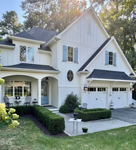a view of a hallway with wooden floor and a living room