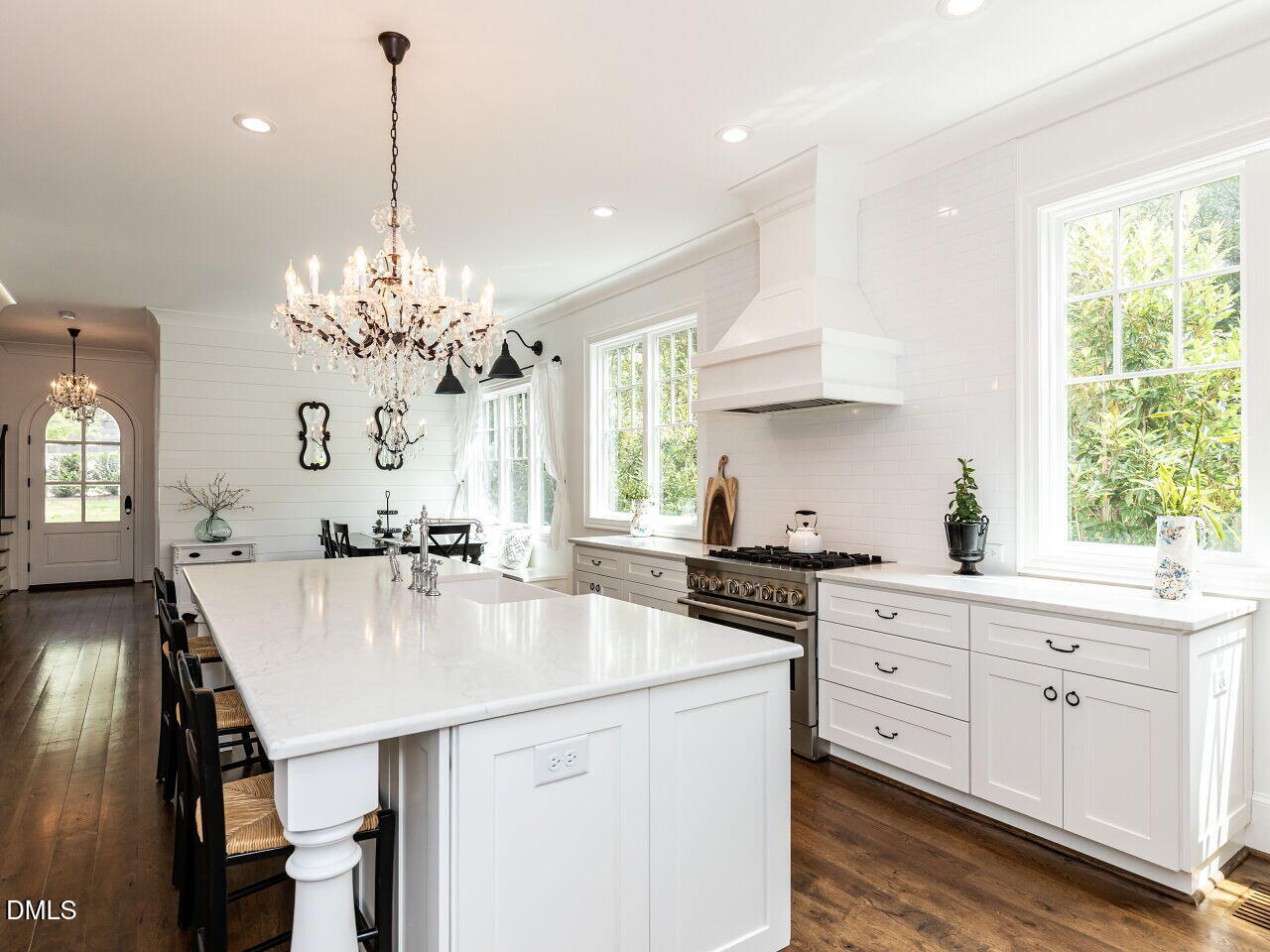 5309 Alpine Drive Raleigh, NC 27609 - Photo 12 of 67 a kitchen with stainless steel appliances a kitchen island a stove a table and chairs in it