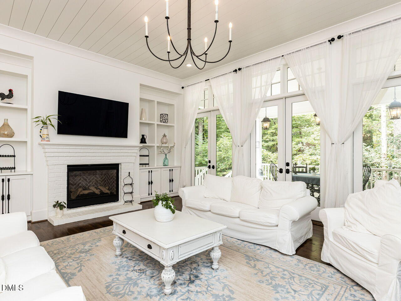 5309 Alpine Drive Raleigh, NC 27609 - Photo 15 of 67 a living room with furniture a flat screen tv and a fireplace
