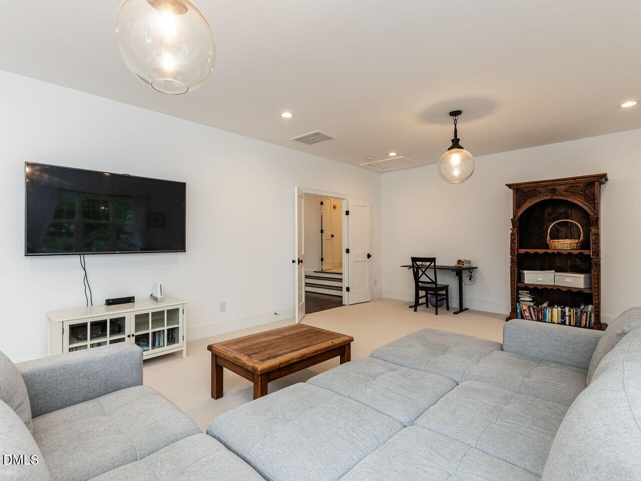 5309 Alpine Drive Raleigh, NC 27609 - Photo 27 of 67 a living room with furniture a flat screen tv and kitchen view