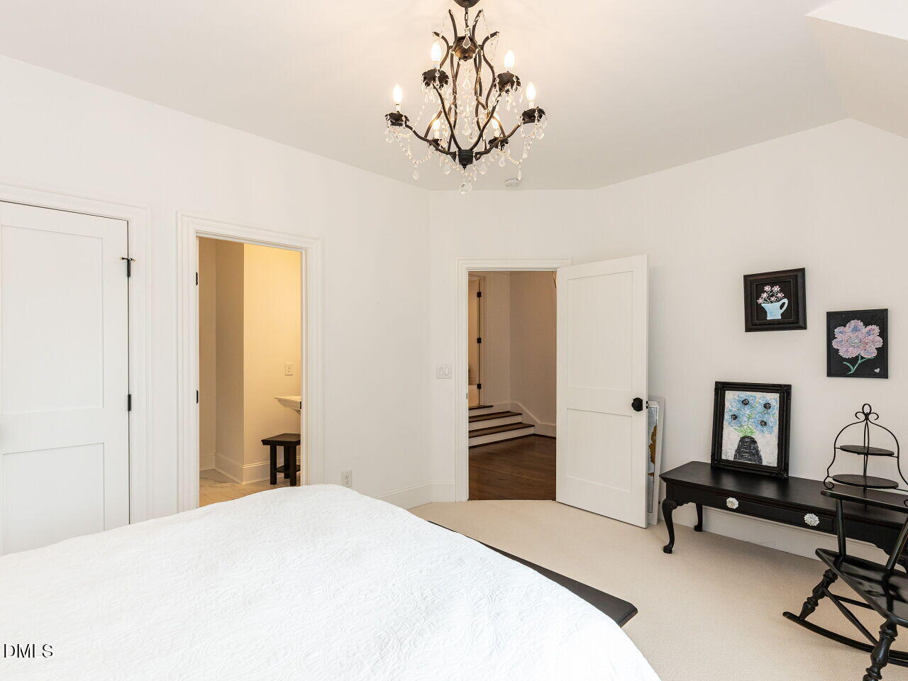 5309 Alpine Drive Raleigh, NC 27609 - Photo 29 of 67 a bedroom with a bed and a chandelier