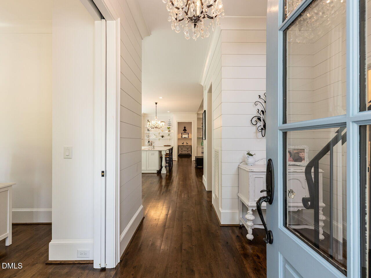5309 Alpine Drive Raleigh, NC 27609 - Photo 3 of 67 a view of a hallway with wooden floor and a living room