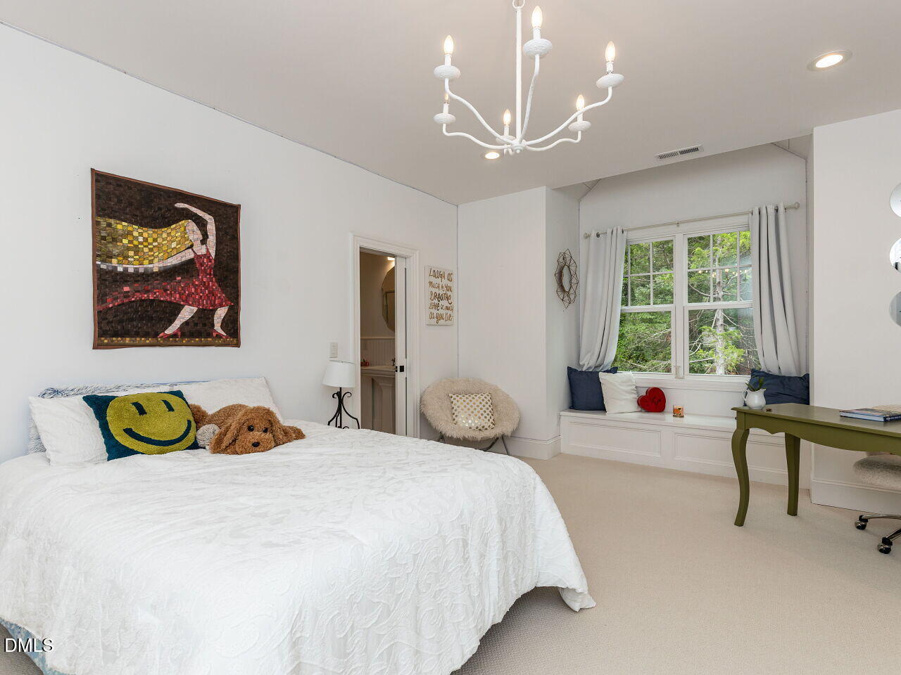 5309 Alpine Drive Raleigh, NC 27609 - Photo 31 of 67 a bedroom with a bed and a chandelier