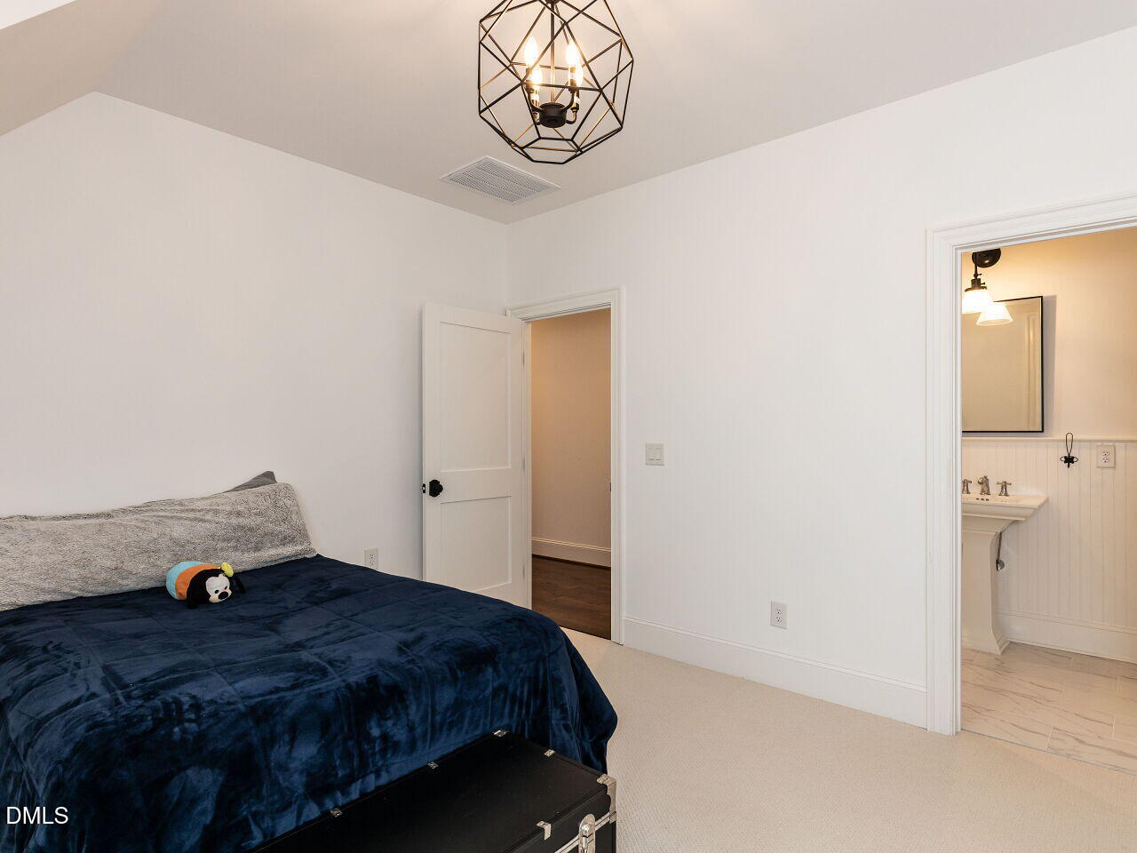 5309 Alpine Drive Raleigh, NC 27609 - Photo 37 of 67 a bedroom with a bed and cabinets