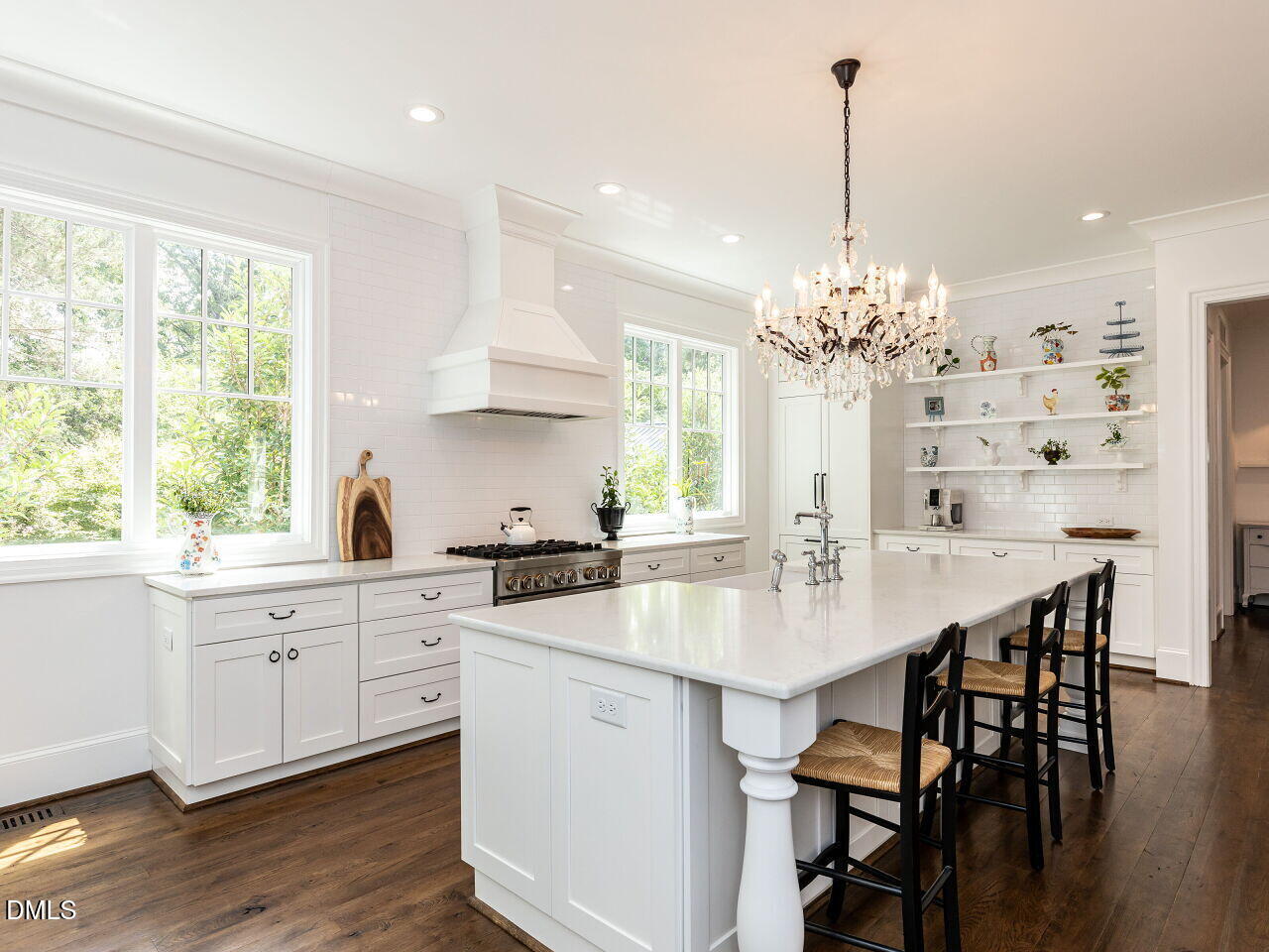 5309 Alpine Drive Raleigh, NC 27609 - Photo 10 of 67 a kitchen with stainless steel appliances a kitchen island a stove a table and chairs in it