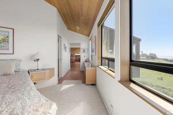 a living room with furniture and floor to ceiling windows
