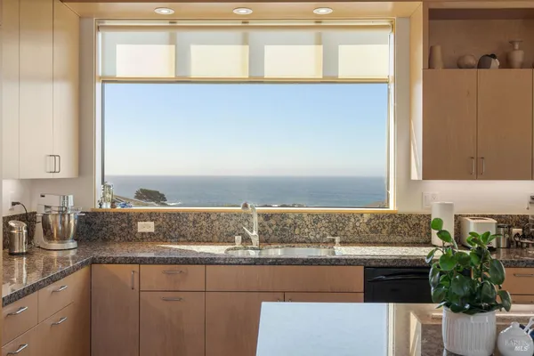 a large kitchen with a table and chairs