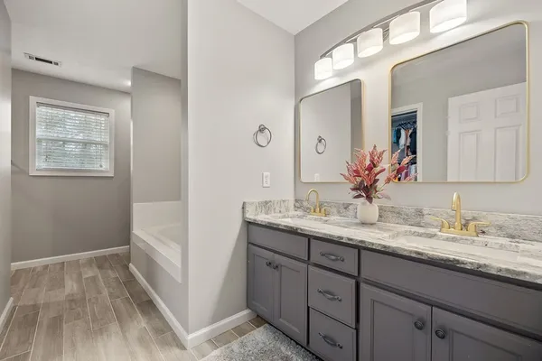 a bathroom with a granite countertop sink mirror and double