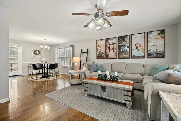 a living room with furniture and wooden floor