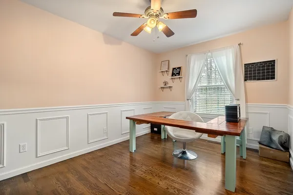 a view of a workspace with furniture and wooden floor