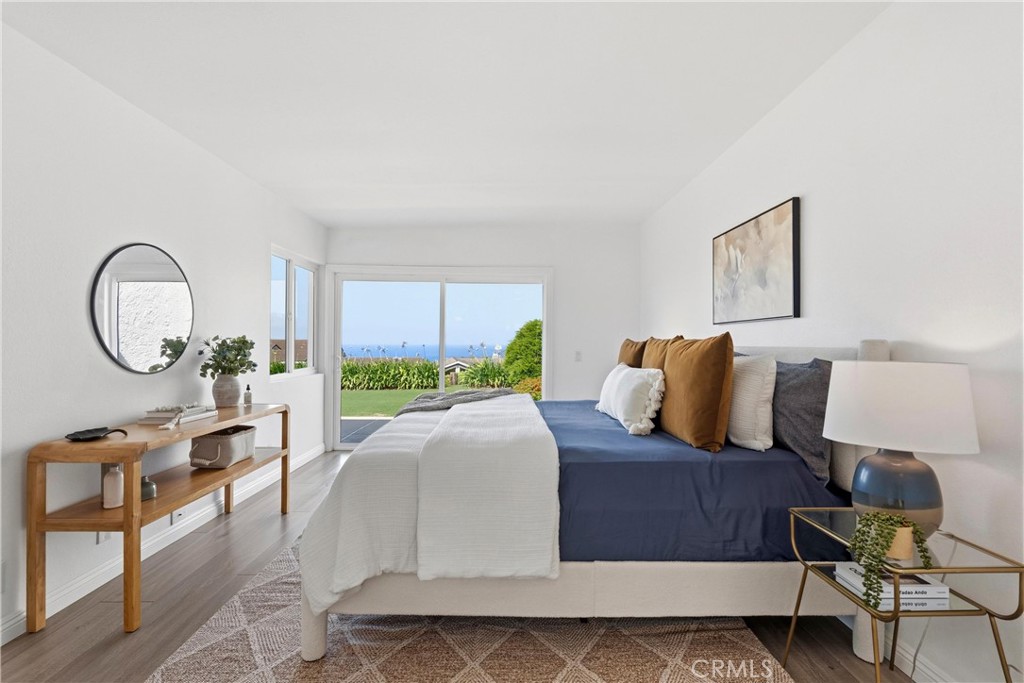33585 Via Corvalian, Unit 7 Dana Point, CA 92629 - Photo 18 of 50 Bright primary suite with vaulted ceilings, private balcony, and ocean views. Light-filled coastal retreat.