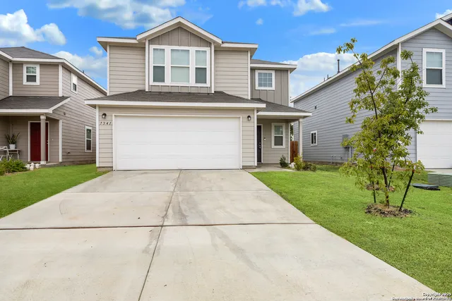 a view of a yard in front view of a house