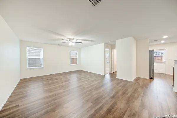 a view of an empty room with wooden floor