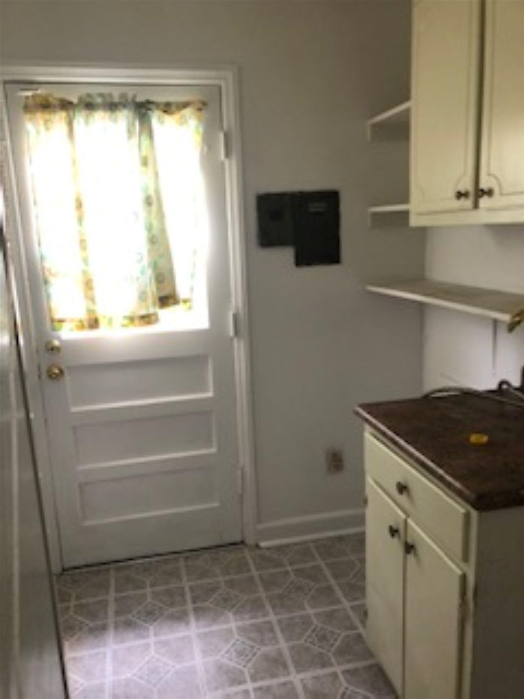 1048 Avon Road Memphis, TN 38122 - Photo 5 of 10 a kitchen with white cabinets and a window