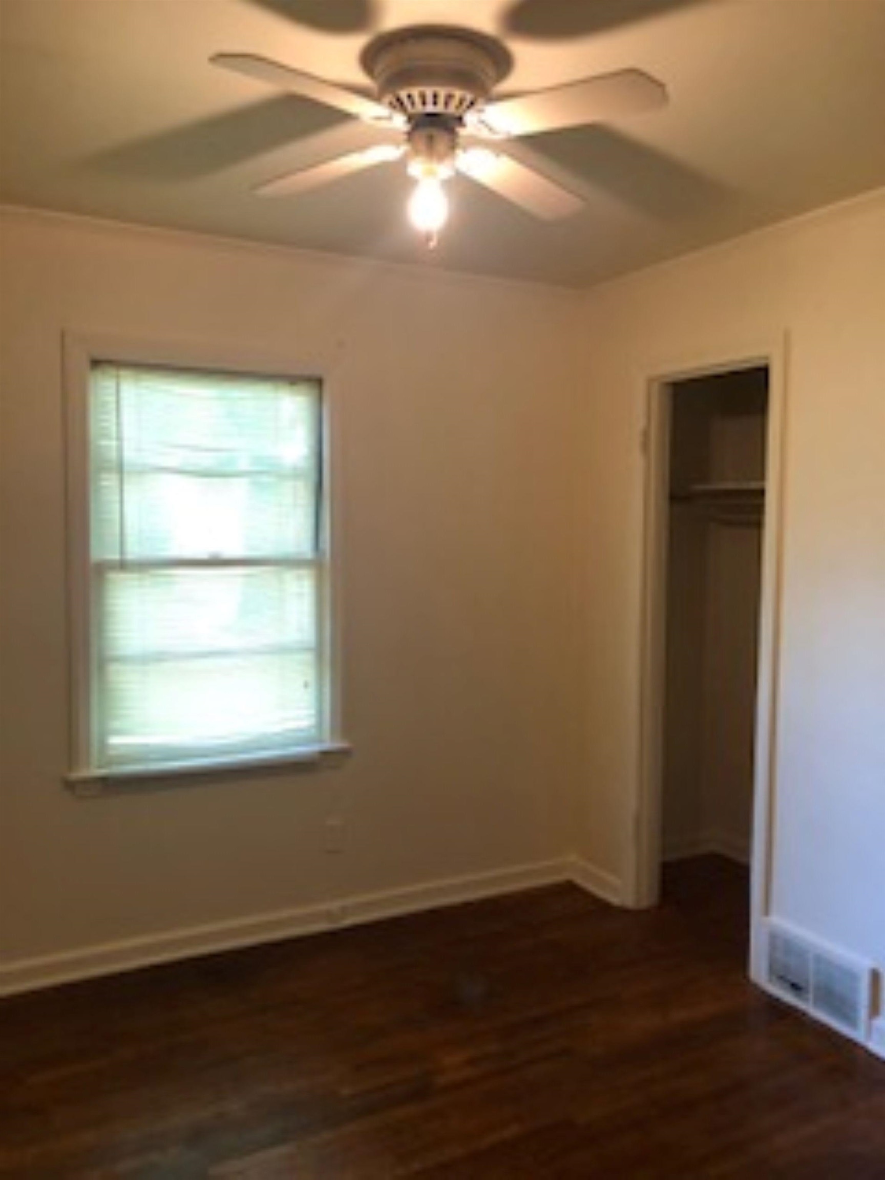 1048 Avon Road Memphis, TN 38122 - Photo 8 of 10 an empty room with wooden floor and windows