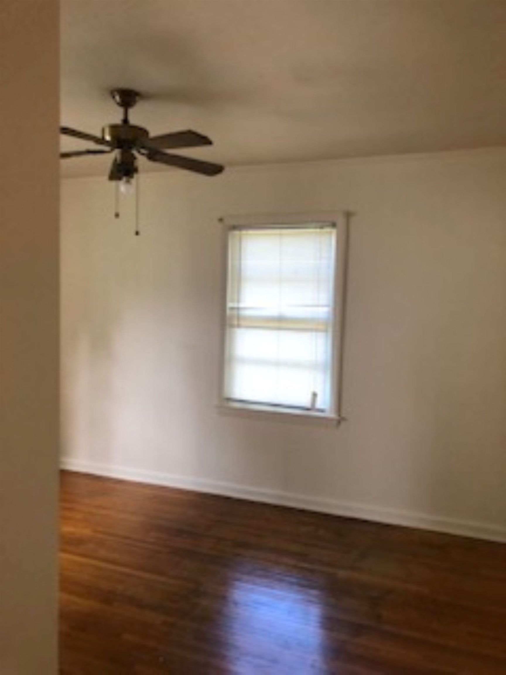 1048 Avon Road Memphis, TN 38122 - Photo 9 of 10 wooden floor in an empty room with a window