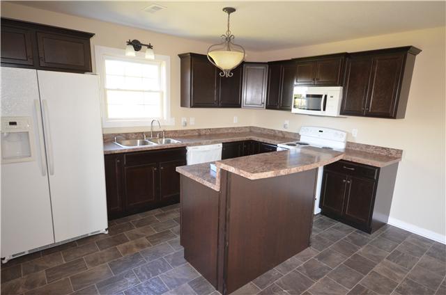 5630 Sango Road Cedar Hill, TN 37032 - Photo 17 of 19 a kitchen with stainless steel appliances granite countertop a sink stove and refrigerator