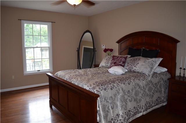 5630 Sango Road Cedar Hill, TN 37032 - Photo 8 of 19 a bedroom with a bed and a potted plant on table
