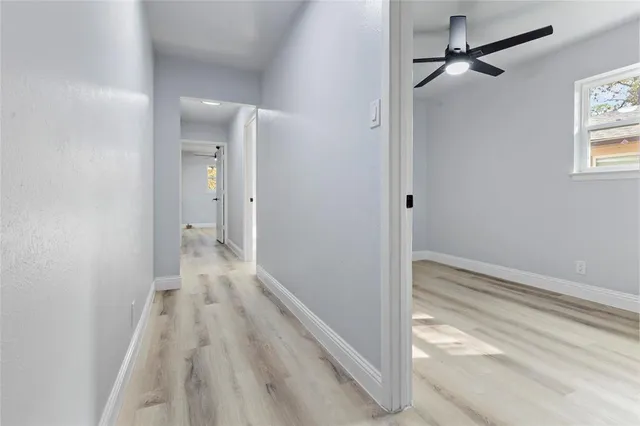 a view of small space with wooden floor and windows