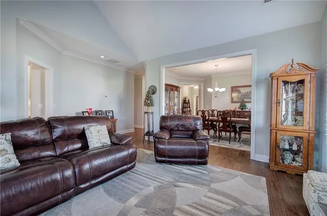 a living room with furniture and wooden floors