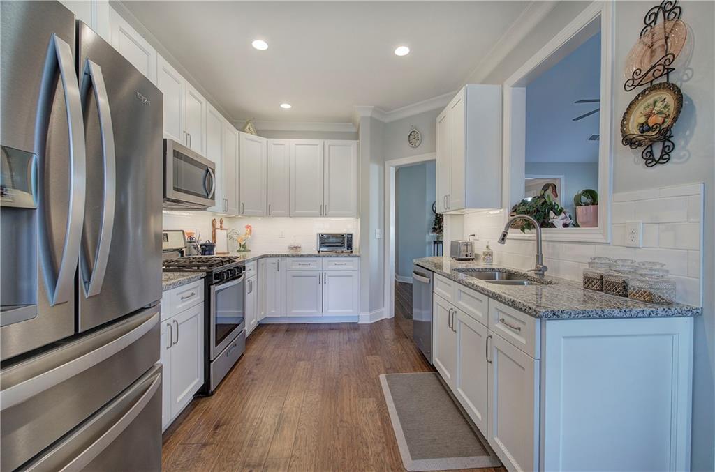 20 Encore Lane Cartersville, GA 30120 - Photo 25 of 44 a kitchen with granite countertop stainless steel appliances cabinets a sink and a counter top space