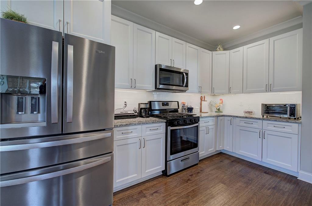 20 Encore Lane Cartersville, GA 30120 - Photo 27 of 44 a kitchen with granite countertop stainless steel appliances and wooden cabinets