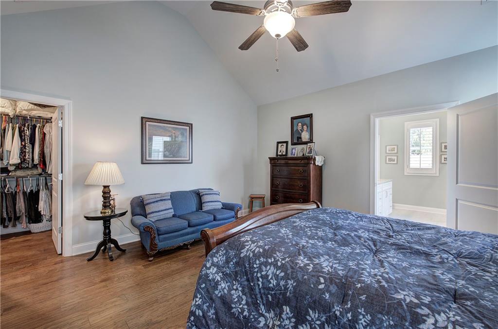 20 Encore Lane Cartersville, GA 30120 - Photo 33 of 44 a spacious bedroom with a bed and a chandelier