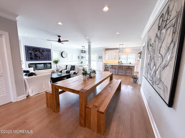 a large living room with stainless steel appliances furniture a rug and a view of kitchen