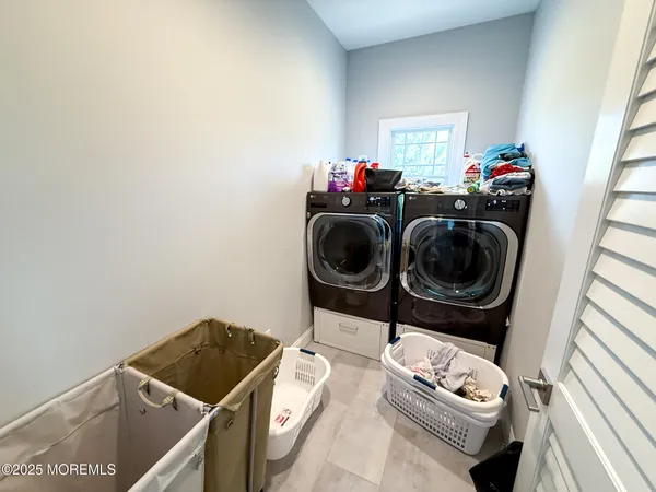 a spacious bedroom with a bed and a dresser