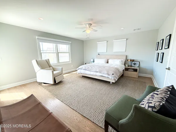 a view of a livingroom with wooden floor and windows