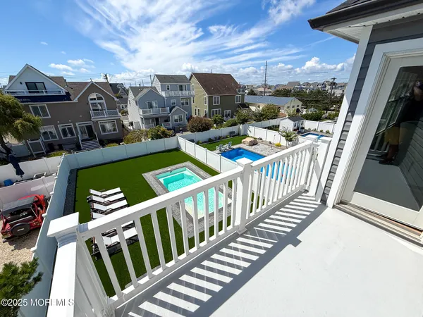 a view of a terrace with lawn chairs